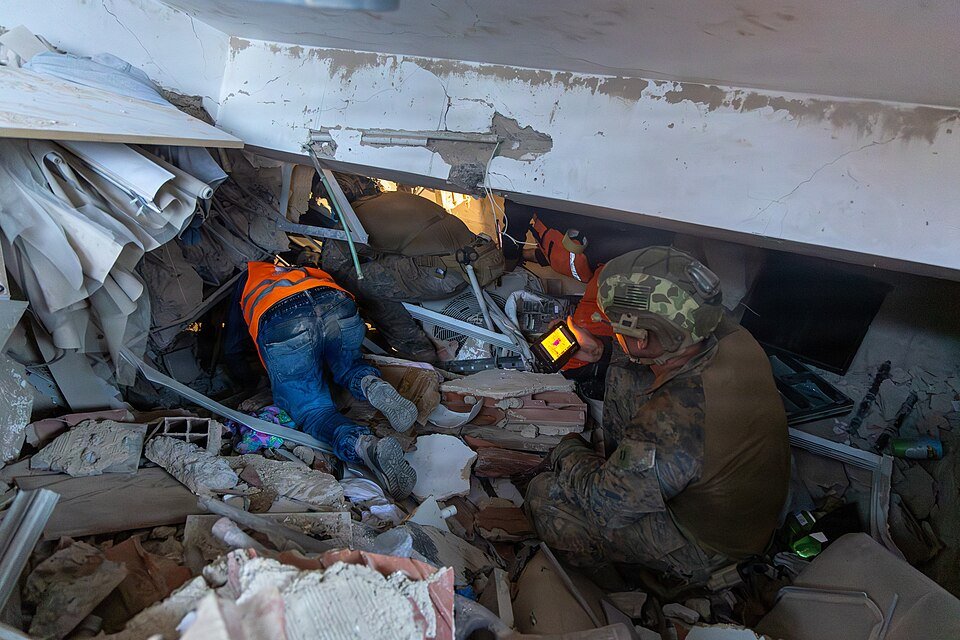 Search and rescue teams working through the rubble